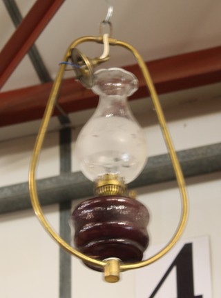 A reproduction Victorian style glass and brass hanging oil lamp 