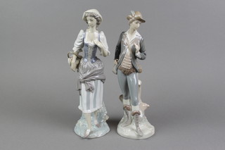 A pair of Lladro figures of a country gentleman and lady on raised bases 11 1/2" 