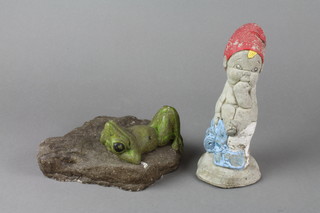 A gnome in the form of a seated child 8" together with a concrete garden figure of a reclining frog 6" 
