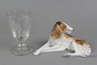 A 19th Century wine glass with cut fern decoration 5 1/2", a Russian figure of a reclining hound 8" 