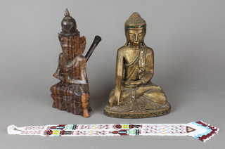 A carved wooden bust of a seated Buddha 10", a carved hardwood pipe in the form of a deity 10" together with American Indian bead work necklace 
