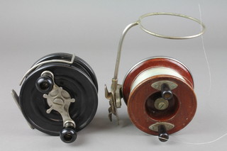 A Steelite black bakelite centre pin fishing reel 5" the reverse marked 29.4 31, together with an Alvey oak and mahogany centre pin fishing reel 4" marked 450/A3  