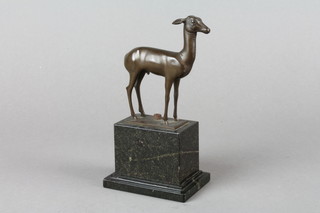 An Art Deco bronze figure of a standing faun raised on a rectangular marble base 7" 