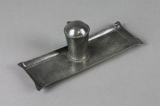 An Art Nouveau rectangular planished pewter inkwell incorporating a pen tray, the base marked J H G 8" 