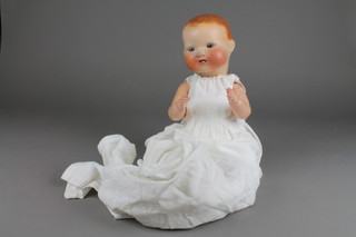An Armand Marseille German porcelain doll with open eyes, 2 teeth and articulated body, the head incised AM Germany 351/4.K