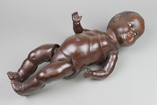 A black porcelain headed doll with open eyes and 2 teeth, the head incised HW6, with articulated body