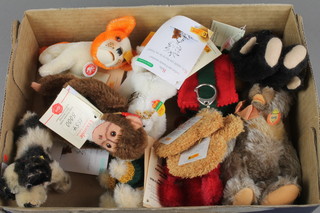 A collection of Steiff figures including a seated dog 4", a black and white dog  4", black bear 5", bird, purses in the form of bears masks etc together with a Herman figure of a monkey  