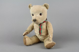 A yellow teddy bear with articulated limbs 