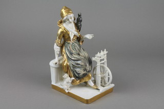 A 19th Century German gilt decorated porcelain figure of a lady seated at a spinning wheel with a kitten beside her 9" f