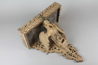 An Indian carved and pierced hardwood wall bracket decorated a mythical beast 17" 