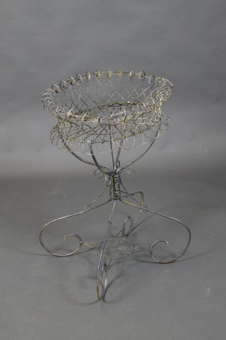 An oval Victorian style wire work planter 30"h x 20" diam