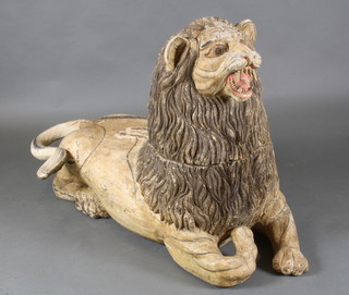 A carved wooden figure of a seated lion 30"h x 24"