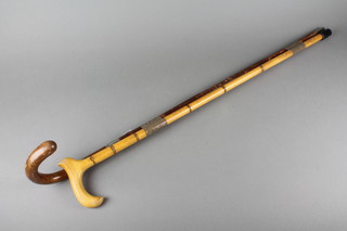A gentleman's umbrella contained in a malacca cane and 1 other walking stick