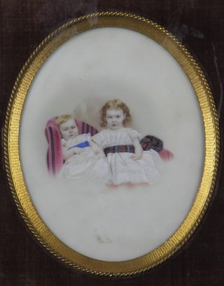 Victorian watercolour, a study of 2 children sitting on a chaise longue, unsigned, framed in the oval in a gilt and velvet inset with tied ribbon gilt frame, 6.25" x 5" 