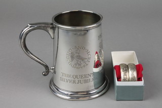 A Queens Silver Jubilee silver commemorative mug with the college of arms, London 1977, 346 grams, a pair of silver napkin rings Birmingham 1983 