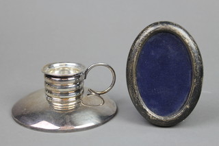 A Continental silver candle holder 4 3/4" and a ditto oval frame