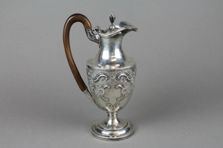 A Victorian repousse silver lidded jug with floral and scroll decoration and vacant cartouche with fruitwood handle, London 1899, approx 398 grams gross