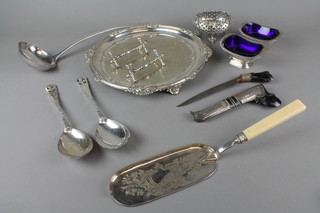 A silver plated chased salver, a pair of knife rests and minor items