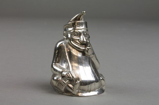 An Edwardian repousse silver novelty pepper in the form of a seated Mr Punch, Birmingham 1903