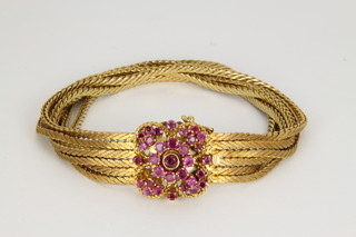 An 18ct yellow gold 6 strand bracelet, set with pink stones, approx 48 grams