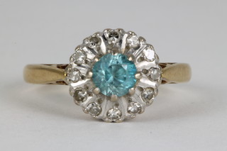 An 18ct blue zircon and diamond cluster ring, the centre stone surrounded by 12 brilliant cut diamonds, size K