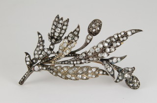 An Antique yellow gold floral spray diamond brooch with articulated mounts