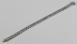 A white gold diamond set "Tennis" bracelet comprising 39 brilliant cut stones, each approx. 0.3ct, total approx. 12cts, gross weight 20 grams