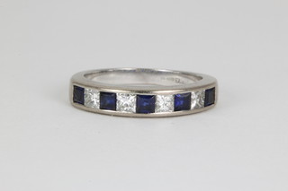 An 18ct white gold princess cut sapphire and diamond ring, size J 1/2
