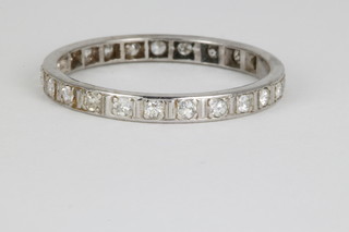 A white gold and diamond eternity ring set with 22 brilliant cut stones and 2 gold spacers, size S 1/2