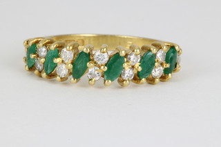 An 18ct yellow gold emerald and diamond dress ring, size N