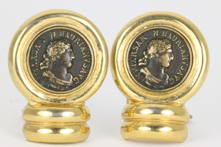 A pair of gilt and faux coin ear clips 