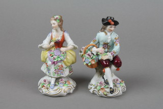 A pair of early 20th Century Continental figures of a couple on raised Rococo bases 5" 