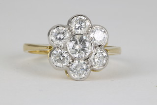 A yellow gold 7 stone diamond cluster ring, approx 1.45ct, size N