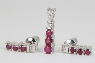 An 18ct white gold diamond and ruby pendant and ditto ensuite ear studs