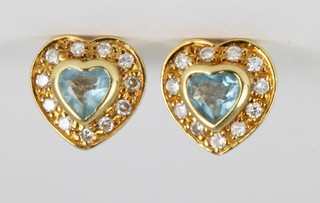 A pair of 18ct gold aquamarine and diamond heart shaped ear studs