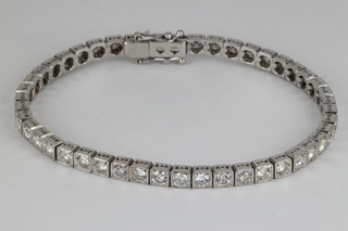 An 18ct white gold diamond set "Tennis" bracelet, approx. 5 ct