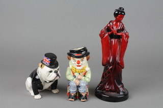 A Royal Doulton figure - The British Bulldog BA228 5 1/2", a Royal Doulton Flambe figure of a geisha (head f) and a character jug.
