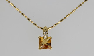 An 18ct yellow gold citrine and diamond pendant on a ditto chain
