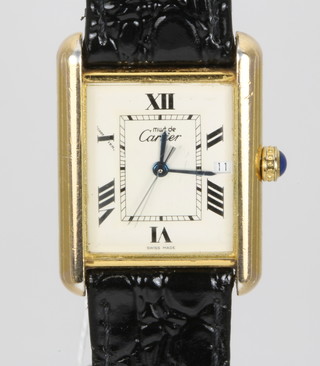A gentleman's silver gilt Must de Cartier wristwatch on a black leather strap