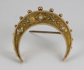 A gold Etruscan style crescent brooch with seed pearls 