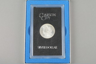 A boxed 1880 silver dollar 