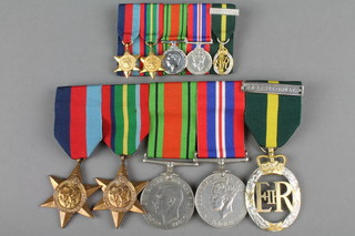 A group of medals. 1939-45 and Pacific Stars, DEF and British War medal, Territorial Decoration 1961 together with miniatures