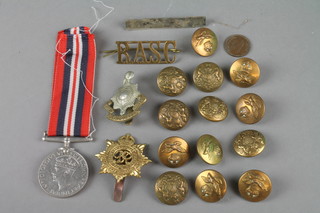 A WWII British War medal, Royal Sussex cap badge and minor badges