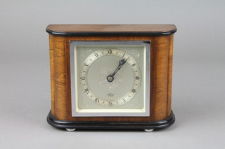 Elliott.   An Art Deco mantel timepiece with silvered dial and Roman numerals contained in a walnut case 