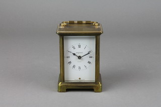 Bayard.  A 20th Century 8 day French carriage clock with enamelled dial and Roman numerals contained in a gilt metal case 
