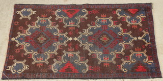 A brown ground Persian Belouche with 2 stylised diamonds to the centre 65" x 33" 