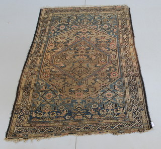 A Persian blue ground rug with red central medallion within a 3 row border 66" x  42"
