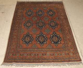 An Afghan rug with 9 octagons to the centre within multi-row borders 115" x 79" 