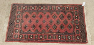 A pink ground Bokhara rug with 20 diamonds to the centre 50" x 32" 