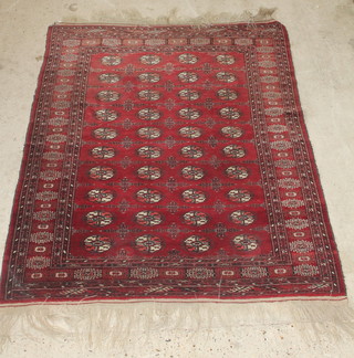 A red ground Bokhara rug having 40 octagons to the centre 56" x 58" 